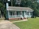 Inviting home with a classic design, featuring a cozy front porch and lush green surroundings at 2012 Ranch Mill Cir, Raleigh, NC 27610
