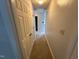 Hallway with carpeted floors and multiple doors at 2012 Ranch Mill Cir, Raleigh, NC 27610