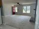 A spacious living room with carpet, brick fireplace, and a large window at 2012 Ranch Mill Cir, Raleigh, NC 27610