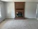 A living room highlighting the brick fireplace and neutral carpet at 2012 Ranch Mill Cir, Raleigh, NC 27610