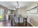 Dining area with a wood table, upholstered chairs and access to a kitchen and outdoor space at 211 Cloverdale Dr, Durham, NC 27703