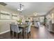 Open floor plan dining room features a wood table, 6 upholstered chairs, and hardwood floors at 211 Cloverdale Dr, Durham, NC 27703
