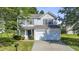 Charming two-story home with a well-maintained lawn and attached two-car garage at 211 Cloverdale Dr, Durham, NC 27703