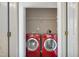 Laundry closet featuring red washer and dryer units, providing a convenient space for laundry tasks at 211 Cloverdale Dr, Durham, NC 27703