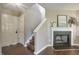 A bright and airy living room features a cozy fireplace and elegant hardwood floors at 211 Cloverdale Dr, Durham, NC 27703