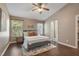 Vaulted ceilings and natural light enhance this main bedroom with neutral decor and dark hardwood floors at 211 Cloverdale Dr, Durham, NC 27703