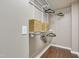 Organized walk-in closet featuring white wire shelving and hardwood floors at 211 Cloverdale Dr, Durham, NC 27703