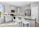 Modern kitchen featuring white cabinetry, stainless steel appliances, and a large island with bar seating at 219 Faith Avenue, Sanford, NC 27330
