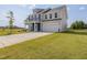 The home is two stories and includes a spacious front yard and two-car garage at 227 Faith Avenue, Sanford, NC 27330