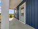 Covered front porch featuring blue vertical siding and a light blue front door at 227 Faith Avenue, Sanford, NC 27330