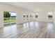 Bright living room features luxury vinyl plank flooring and multiple windows at 227 Faith Avenue, Sanford, NC 27330