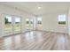 Spacious and bright living room with luxury vinyl plank flooring and large windows at 227 Faith Avenue, Sanford, NC 27330