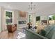 Bright living room with a fireplace, comfortable seating, and natural light streaming through large windows and sliding glass door at 235 Faith Avenue, Sanford, NC 27330