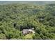 Stunning aerial view of estate home surrounded by lush forest and professionally landscaped yard at 267 Bald Eagle Dr, Pittsboro, NC 27312