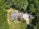 Aerial view of the home showing the large lot with lush trees, a well-manicured lawn, and private driveway at 267 Bald Eagle Dr, Pittsboro, NC 27312