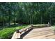 Wooden deck with ample seating, surrounded by lush trees and greenery, perfect for outdoor gatherings and relaxation at 267 Bald Eagle Dr, Pittsboro, NC 27312