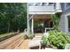 Expansive deck with dining area, lounge chairs, and lush landscaping offering a relaxing outdoor living space at 267 Bald Eagle Dr, Pittsboro, NC 27312