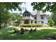 Scenic backyard with a stone fireplace surrounded by chairs, and the home's elegant architecture at 267 Bald Eagle Dr, Pittsboro, NC 27312