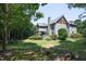 Lush backyard featuring a stone fireplace with ample green space and well-maintained landscaping at 267 Bald Eagle Dr, Pittsboro, NC 27312