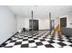 Finished basement features a checkerboard floor, black support poles, and neutral colored walls at 267 Bald Eagle Dr, Pittsboro, NC 27312