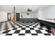Finished basement with a checkerboard floor, a ceiling fan and a gray sofa at 267 Bald Eagle Dr, Pittsboro, NC 27312