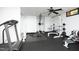 Home gym boasts a ceiling fan, workout machines, and weights on a black rubber floor at 267 Bald Eagle Dr, Pittsboro, NC 27312