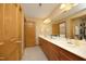 Bathroom boasts double sinks with wood cabinets, a large mirror and neutral decor at 267 Bald Eagle Dr, Pittsboro, NC 27312