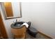 Half-bathroom with a wood vanity, modern sink, toilet, mirror, and tiled floors at 267 Bald Eagle Dr, Pittsboro, NC 27312