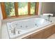 A relaxing soaking tub by a large window with lush greenery views at 267 Bald Eagle Dr, Pittsboro, NC 27312