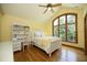 Bright bedroom with yellow walls, a ceiling fan, wood floors and a large window at 267 Bald Eagle Dr, Pittsboro, NC 27312