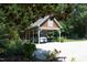 A covered carport with a van and jet skis parked beneath, surrounded by lush greenery and trees at 267 Bald Eagle Dr, Pittsboro, NC 27312
