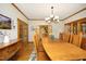 Dining room featuring hardwood floors, natural light, and an elegant chandelier at 267 Bald Eagle Dr, Pittsboro, NC 27312