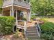 Multi-level deck and lush landscaping enhance the home's exterior, creating an inviting outdoor living space at 267 Bald Eagle Dr, Pittsboro, NC 27312