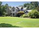 A charming home with stone and siding, a manicured lawn, and lush greenery, creating a welcoming curb appeal at 267 Bald Eagle Dr, Pittsboro, NC 27312