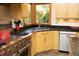 Close-up of the kitchen's stainless steel range, granite countertops, and wood cabinets at 267 Bald Eagle Dr, Pittsboro, NC 27312