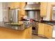Spacious kitchen boasts a large island, stainless appliances, granite counters, and wood cabinetry at 267 Bald Eagle Dr, Pittsboro, NC 27312