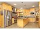 Modern kitchen with stainless steel appliances, custom cabinetry, and center island at 267 Bald Eagle Dr, Pittsboro, NC 27312
