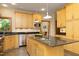 Bright kitchen features wood cabinets, granite countertops, and stainless steel appliances at 267 Bald Eagle Dr, Pittsboro, NC 27312