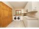 Laundry room equipped with washer, dryer, sink, storage cabinets, and a window at 267 Bald Eagle Dr, Pittsboro, NC 27312