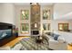 Spacious living room with a stone fireplace, hardwood flooring, and abundant natural light at 267 Bald Eagle Dr, Pittsboro, NC 27312