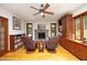 Charming living room with built-in shelves, a stone fireplace, and a ceiling fan at 267 Bald Eagle Dr, Pittsboro, NC 27312