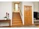 Interior view of a wooden staircase with tile flooring and wooden door at 267 Bald Eagle Dr, Pittsboro, NC 27312