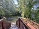 Backyard features plenty of shade with mature trees and wooden patio at 2907 S S Roxboro St, Durham, NC 27707