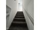 Carpeted stairs with handrail lead to the upper level of this home at 2907 S S Roxboro St, Durham, NC 27707