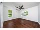 Bright bedroom featuring hardwood floors, white walls, and two windows that bring in natural light at 311 Troy St, Creedmoor, NC 27522
