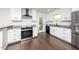 Modern kitchen with white cabinets, stainless appliances and granite countertops at 311 Troy St, Creedmoor, NC 27522