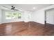 Bright living room featuring hardwood floors, natural light, and a modern ceiling fan at 311 Troy St, Creedmoor, NC 27522