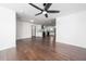 Open-concept living space boasts hardwood floors, ceiling fan and flows into a modern kitchen at 311 Troy St, Creedmoor, NC 27522