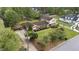 Aerial view of home with long driveway and lush green lawns and mature landscaping at 315 Crescent Dr, Clayton, NC 27520