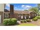 A brick home with several windows and doors surrounded by lush landscaping at 315 Crescent Dr, Clayton, NC 27520